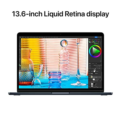 MacBook with 13.6-inch Liquid Retina display showing colorful design software.