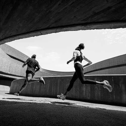 Two people running in an urban environment.